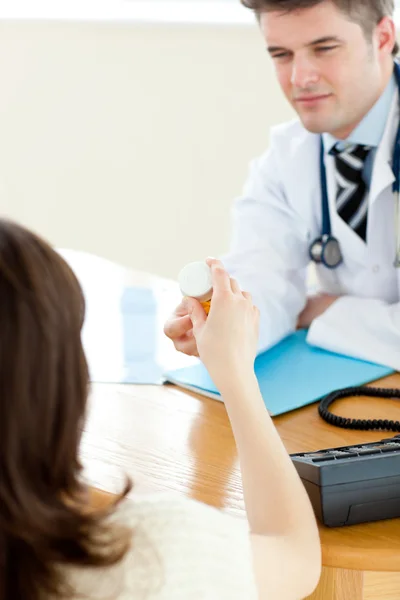 Young male doctor giving pills to a paient — Stock Photo, Image
