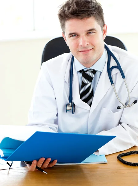 Self-assured doctor reading a report — Stock Photo, Image