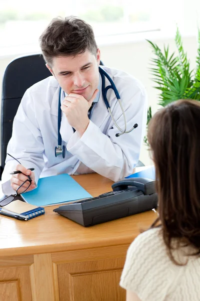 Self-assured doctor talking with a female patient — Stock Photo, Image