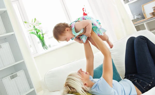 Merry mother playing with her daughter — Stock Photo, Image