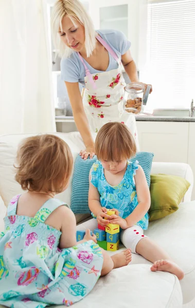 Woman playing with her daughters — Stock Photo, Image