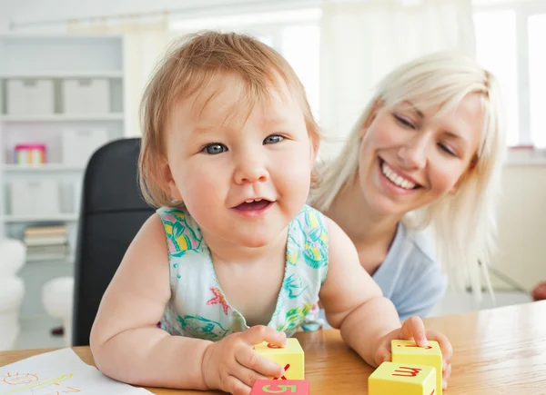 Glad mother playing with her daughter — Stock Photo, Image
