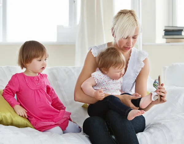 Smiling mother playing with her daughters — Stock Photo, Image
