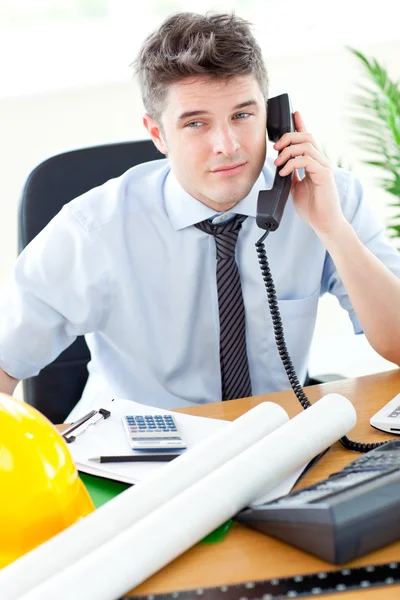 Attractive businessman in front of his desk — Stock Photo, Image