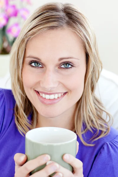 Glowing woman holding cup — Stock Photo, Image