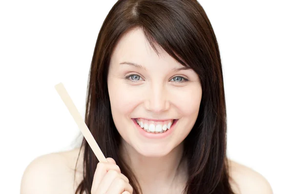 Portrait of a glowing young woman holding a nail file — Stock Photo, Image