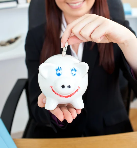 Close-up of a young businesswoman holding a piggibank — Stock Photo, Image