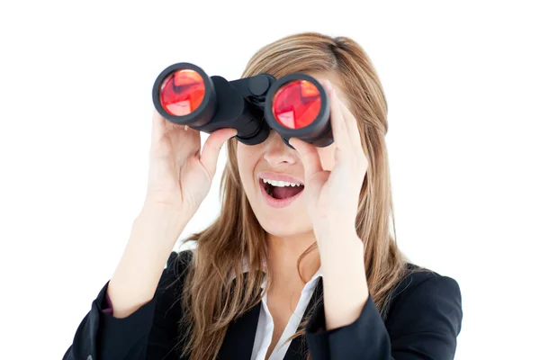 Fascinated young businesswoman looking through a spyglass — Stock Photo, Image