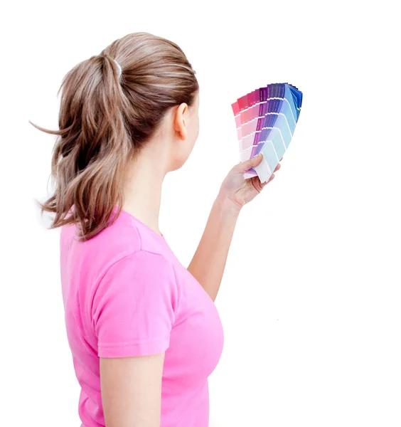 Blond young woman choosing colours in her living-room — Stock Photo, Image