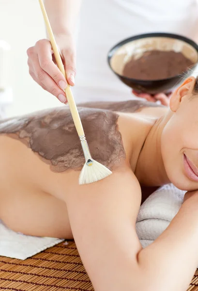 Charming woman enjoying a mud skin treatment — Stok fotoğraf