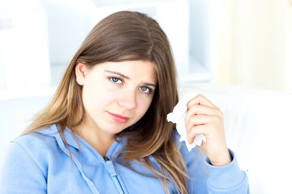 Upset young woman holding a tissue — Stock Photo, Image