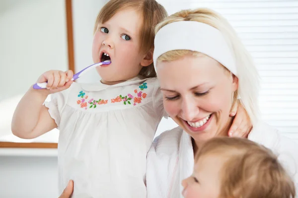 Attractive mother taking care of her children — Stock Photo, Image