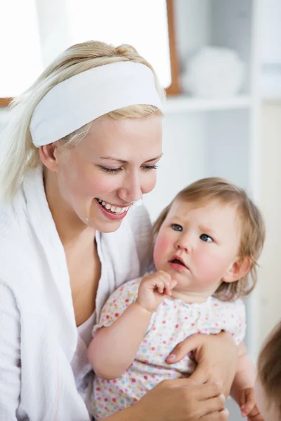 Laughing mother taking care of her children — Stock Photo, Image