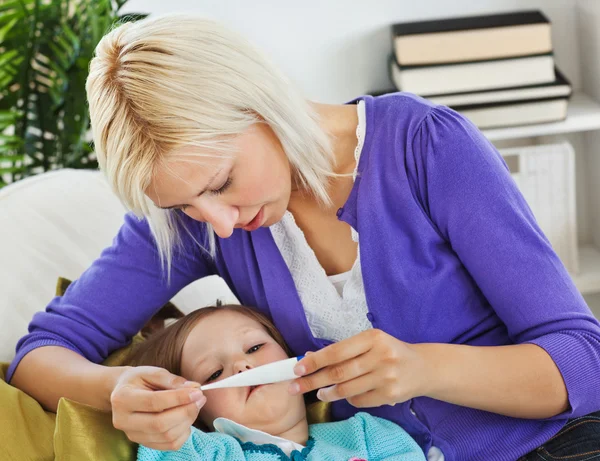Mother taking care of her sick child — Stock Photo, Image