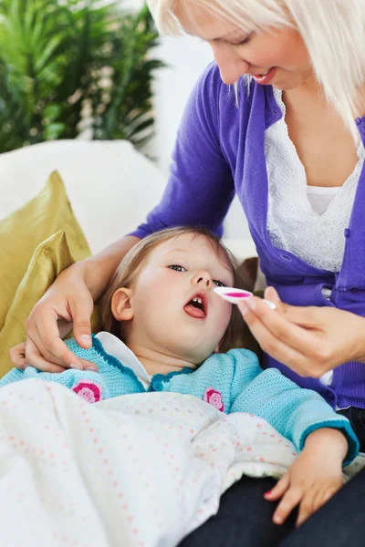 Young woman taking care of her child — Stock Photo, Image