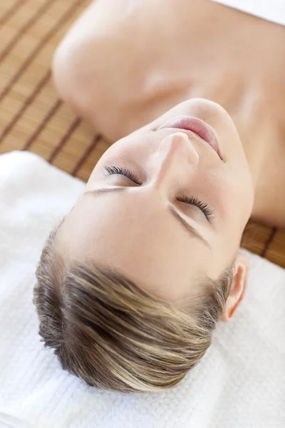 Portrait of a beautiful young woman lying on a massage table — Stock Photo, Image