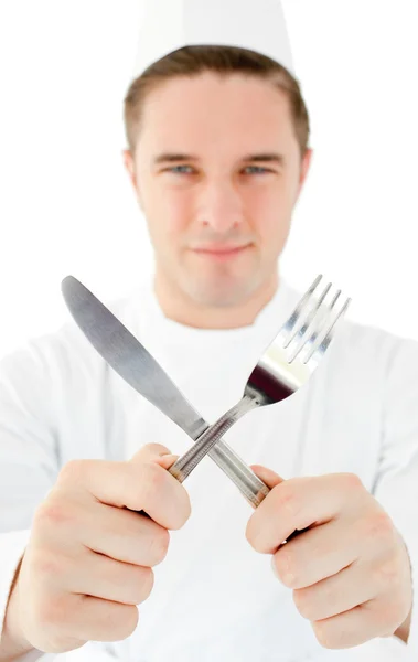 Handsome cook holding cutlery — Stock Photo, Image