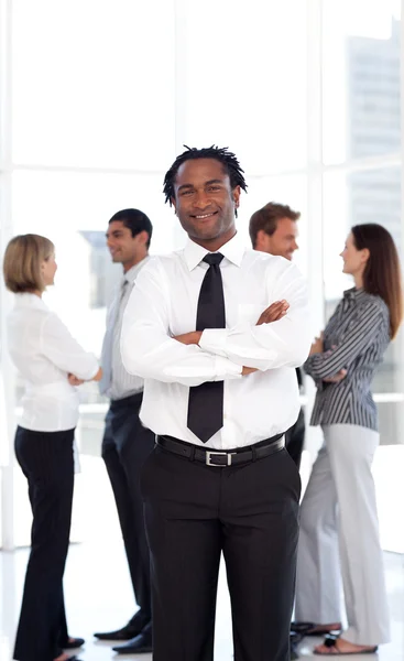 African male manager standing at the camera with his team — Stock Photo, Image