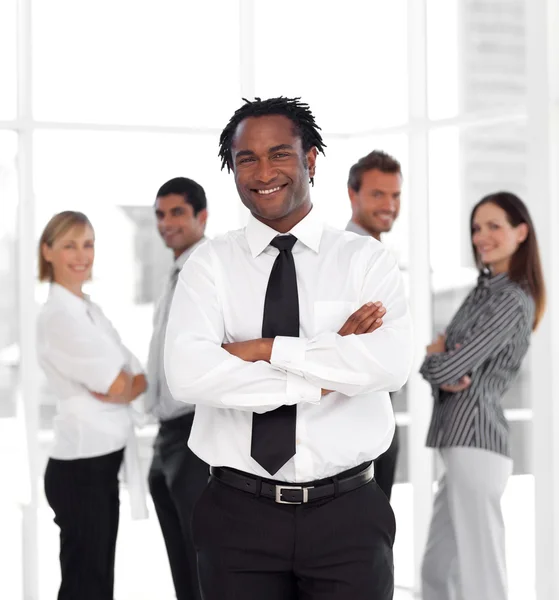 Smiling male manager standing at the camera with his team — Stock Photo, Image