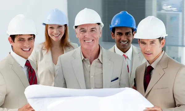 Architects with hardhats in a building site — Stock Photo, Image