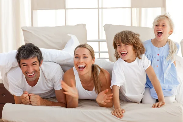 Laughing parents playing with their children — Stock Photo, Image