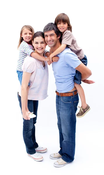 Loving parents giving their children a piggyback ride Royalty Free Stock Images