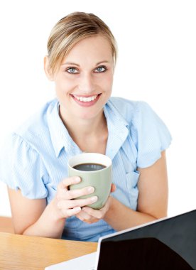 Glowing businesswoman drinking coffee smilng at the camera clipart