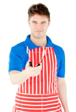 Handsome young cook holding a cookware clipart
