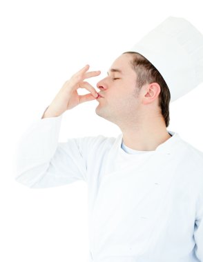 Serious male cook showing the sign for delicious clipart