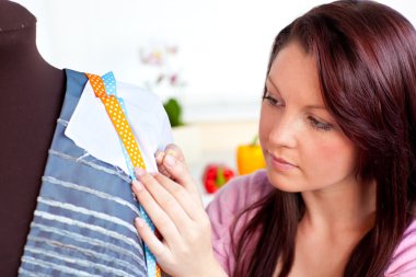 Concentrated woman sewing at home clipart