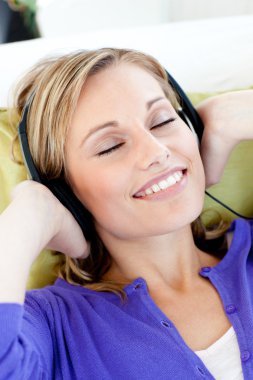 Relaxed woman listen to music with closed eyes clipart