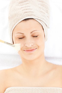 Charming relaxed woman receiving beauty treatment clipart