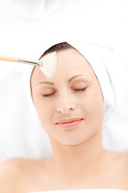 Relaxed woman having a beauty treatment clipart