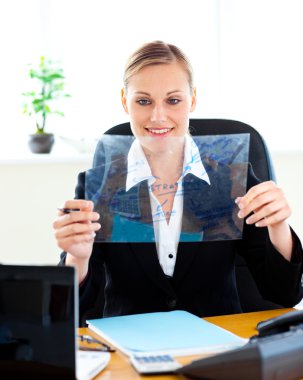 Confident businesswoman preparing slides for a presentation in h clipart