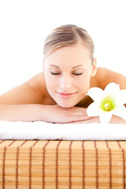 Close-up of a delighted woman lying on a massage table with a fl clipart