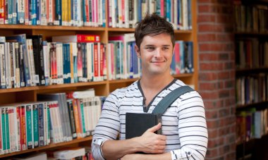 Attractive man holding a book clipart