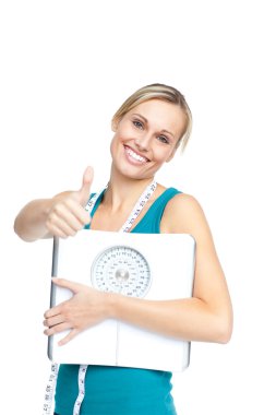 Attractive young woman holding a weight scale clipart