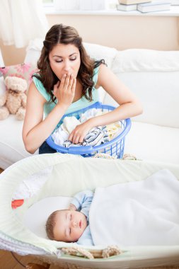 Beautiful mother surprised seeing her baby sleeping peacefully i clipart