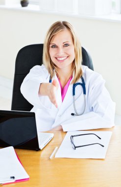 Joyful female doctor ready to shake hands with a patient clipart