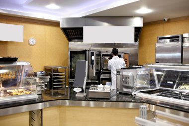 View of a kitchen with baker preparing breads and baguettes in a clipart