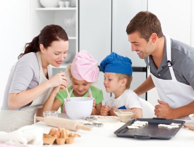 Adorable family baking together in the kitchen clipart