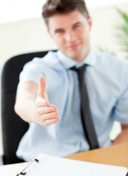 Self-assured businessman reaching his hand to the camera — Stock Photo, Image