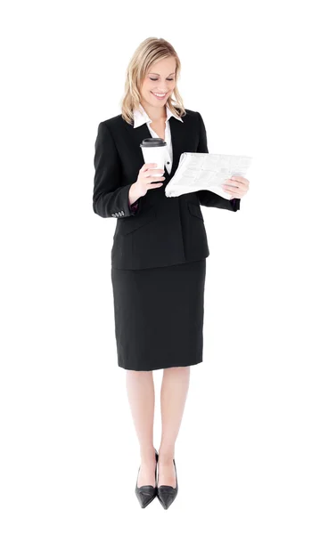 Attractive businesswoman reading a newspaper holding a coffee — Stock Photo, Image
