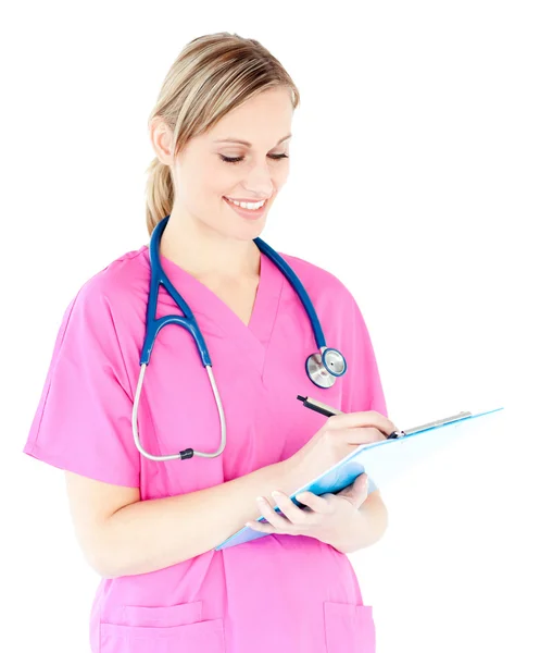 Ambitious female surgeon writing on a clipboard — Stock Photo, Image