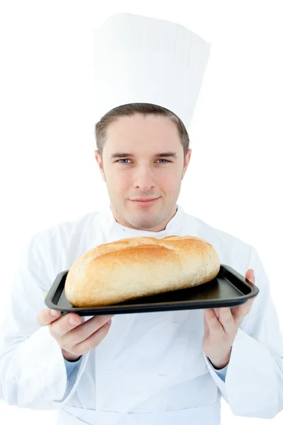 Charismatic male cook holding a bread into the camera — Stock Photo, Image