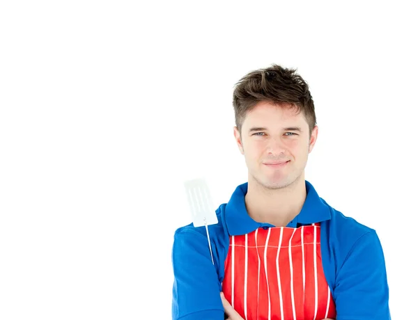 Charming young cook holding a cookware — Stock Photo, Image