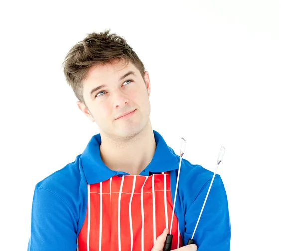 Thougtful young cook holding a cookware — Stock Photo, Image