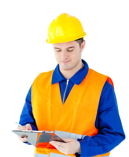 Charming young worker writing on a clipboard — Stock Photo, Image