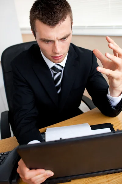 Astonished businessman looking at his laptop — Stock Photo, Image
