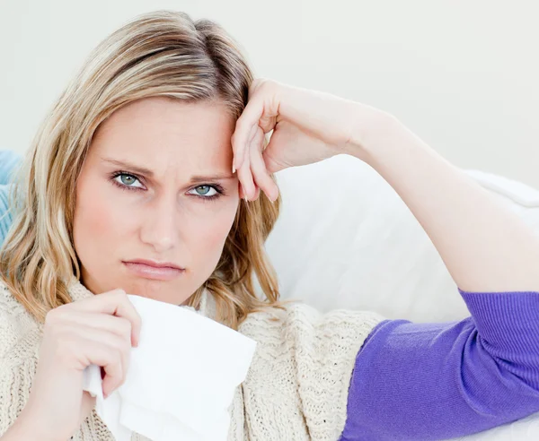 Unhappy sick woman holding tissues looking at the camera — Stock Photo, Image